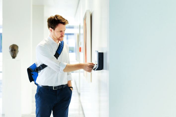 TRUMPF employee leaving the building to work at home