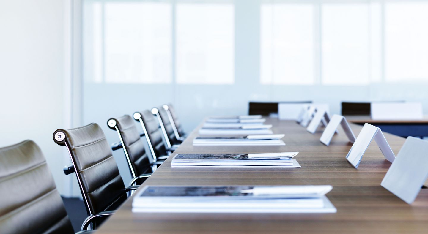 Meeting room with chairs, tables and some accessories on the table 