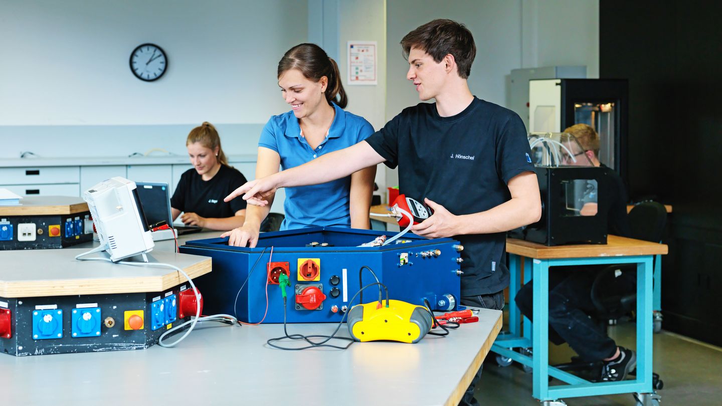 TRUMPF apprentice interacting with a trainer