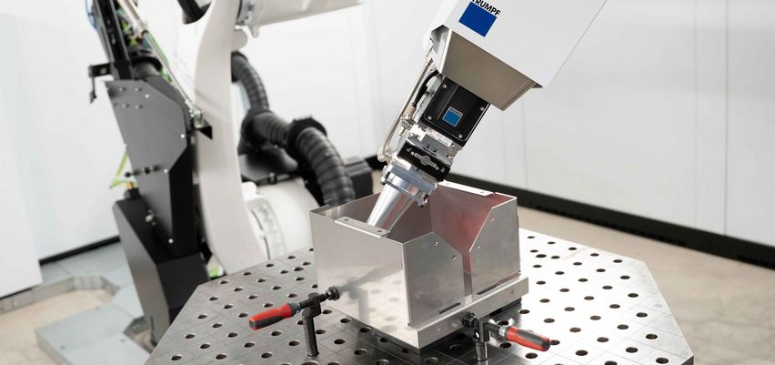 The welding optics of the TruLaser Weld 3000 is processing a metal housing